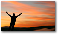 Man with outstretched arms facing a beautiful suns
